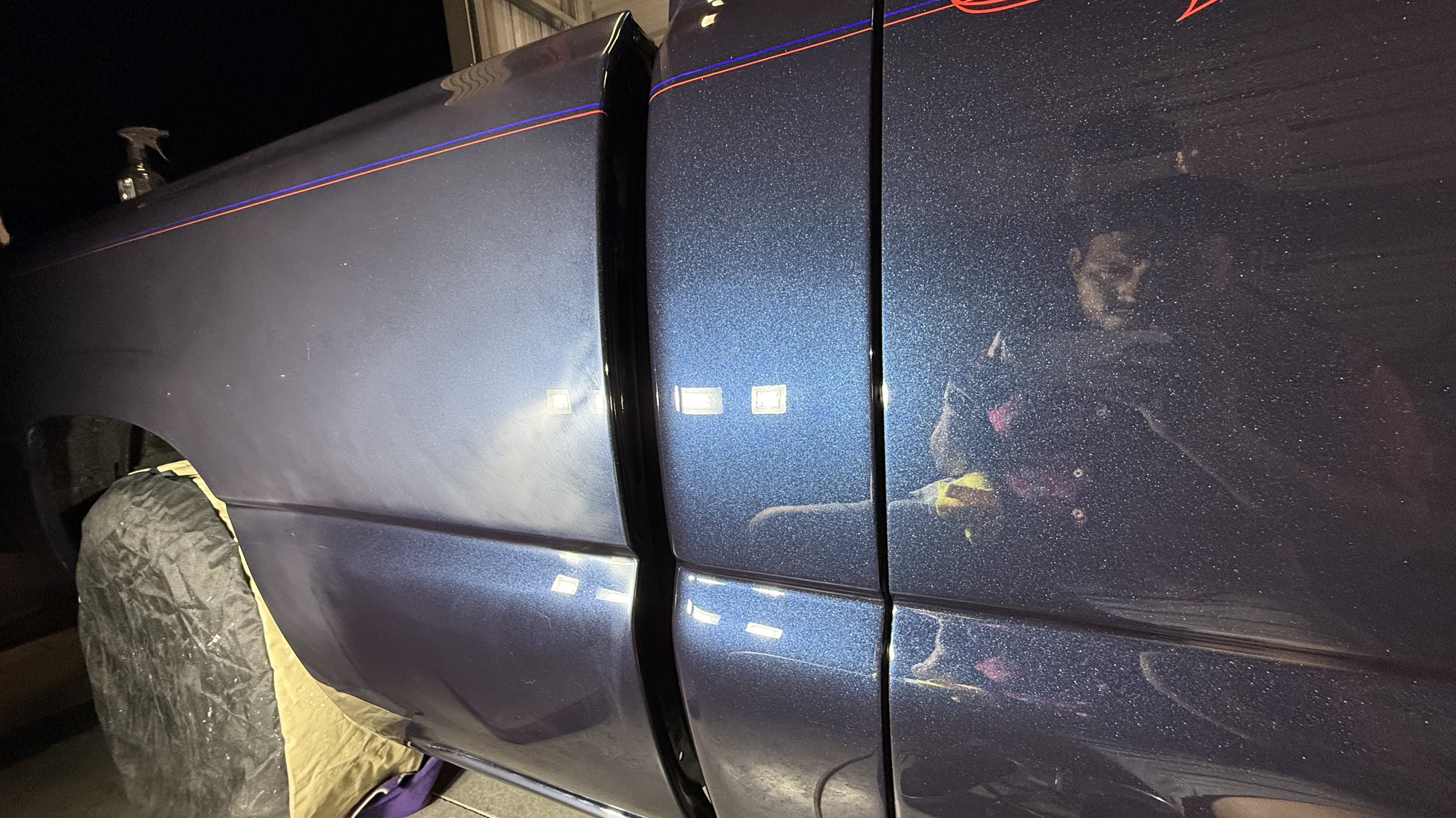 Person visible inside dark van at night with illuminated windows and neon trim.