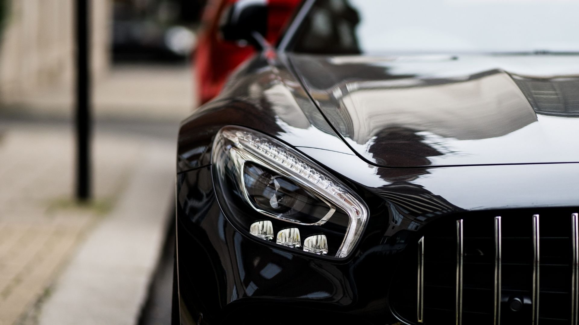 Close-up of black SUV headlight with LED daytime running lights